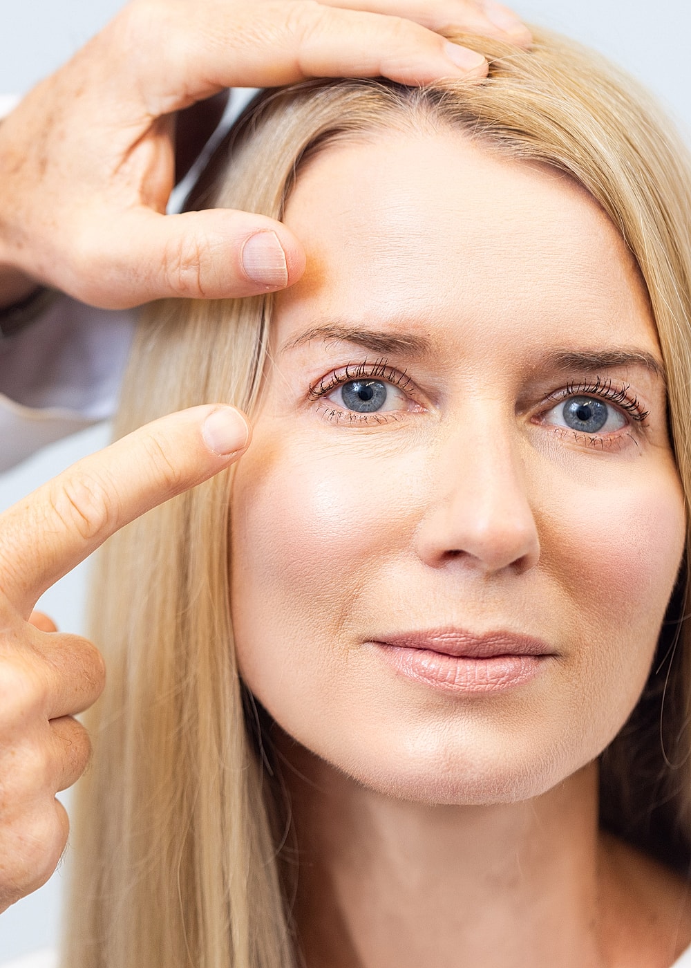 Close-up of woman receiving facial treatment.