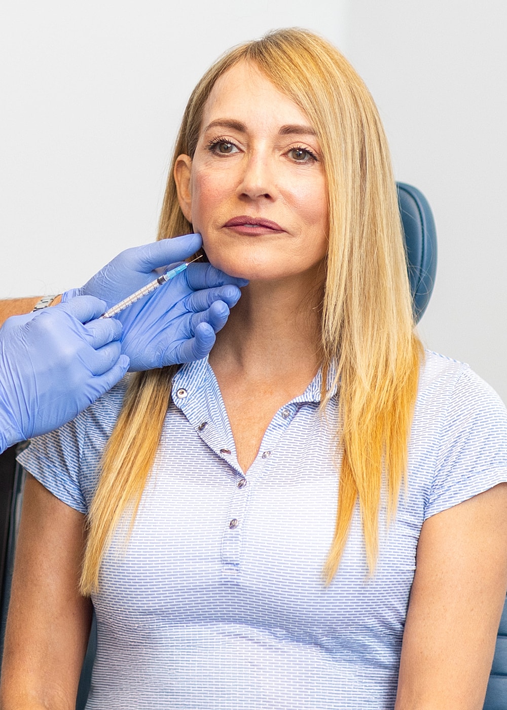 Woman receiving cosmetic treatment in a clinic.