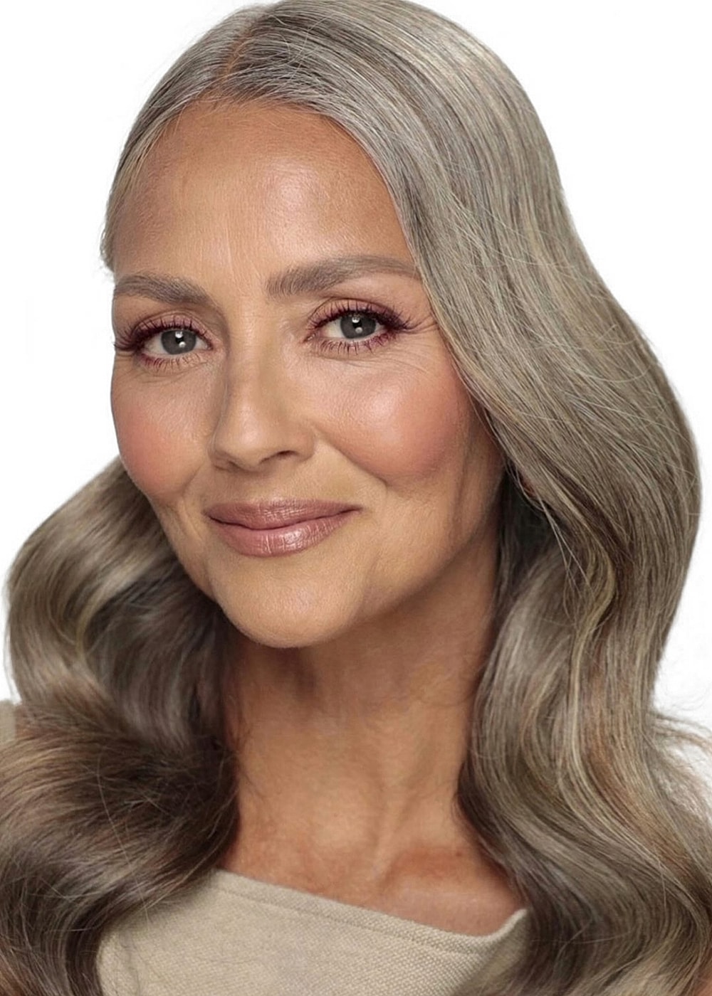 Smiling woman with long silver hair and makeup.