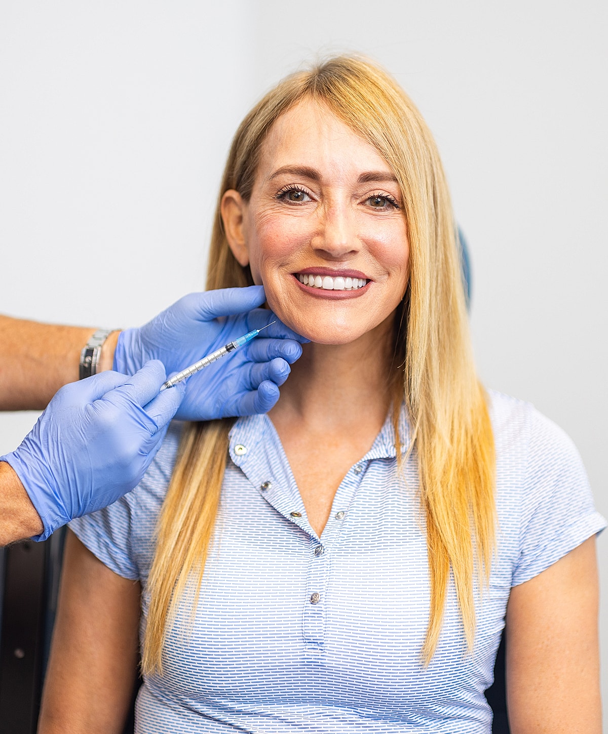 Patient receiving cosmetic treatment in clinic setting.