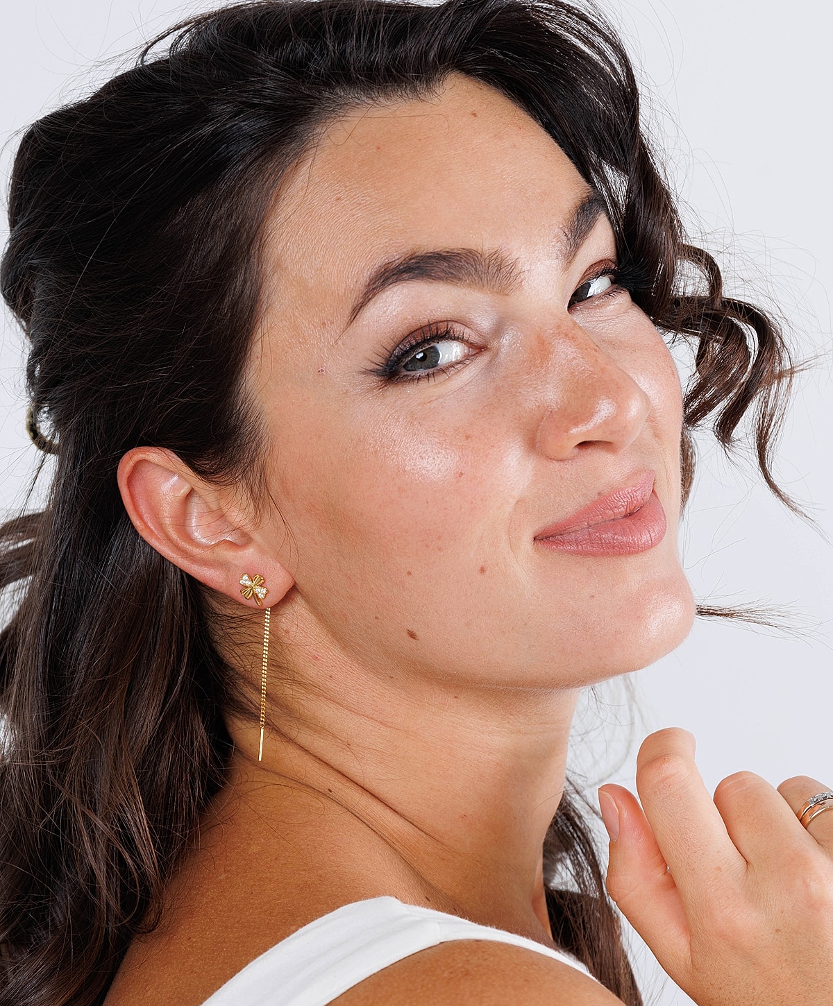 Woman with long earrings and wavy hair.