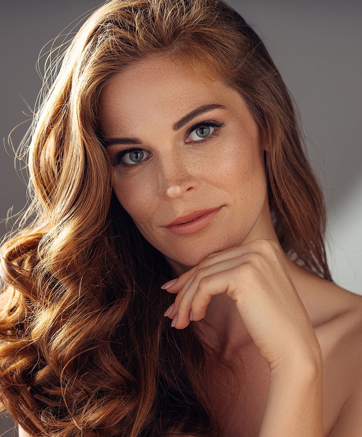 Woman with long, wavy hair and soft expression
