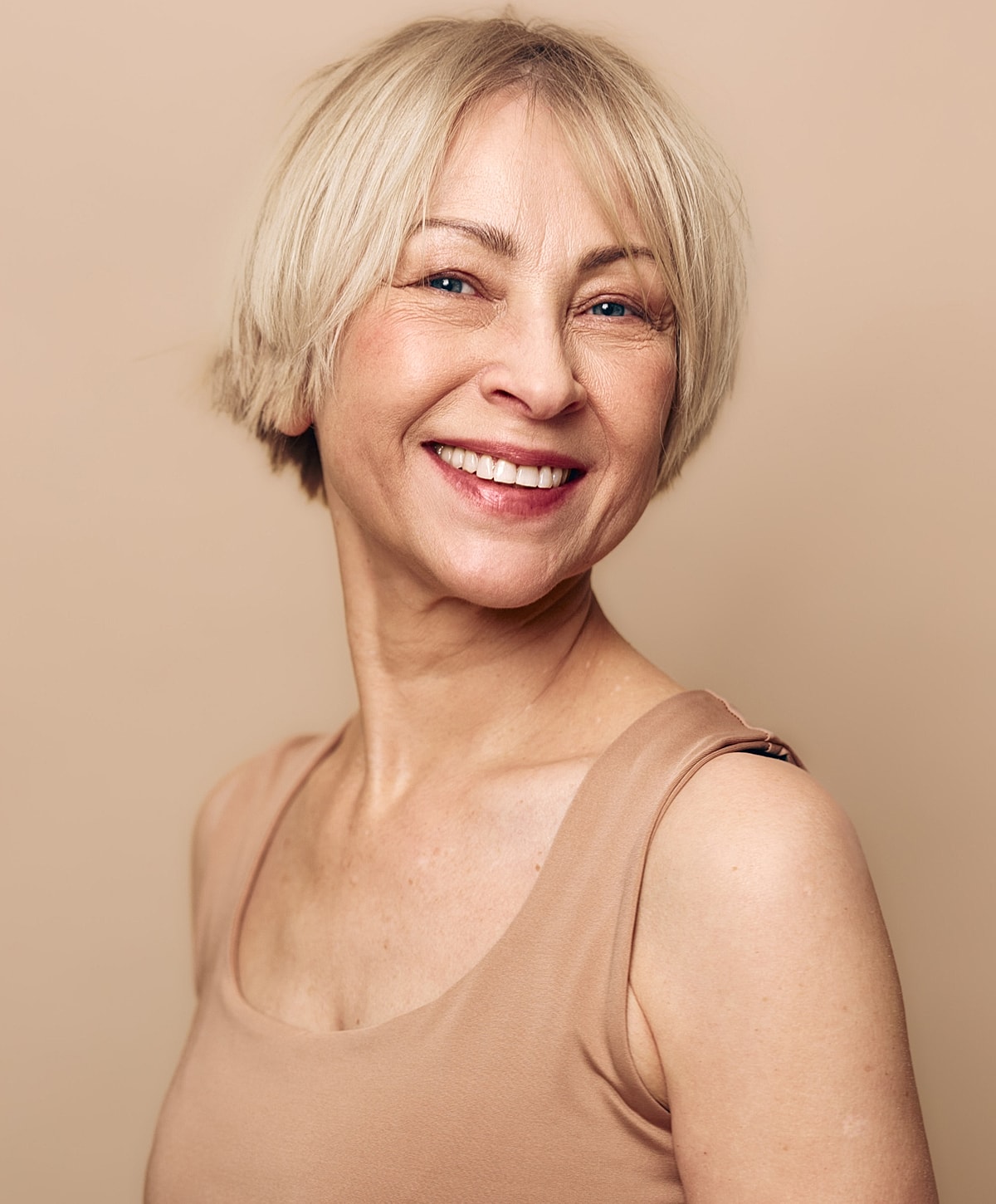 Smiling woman with short blonde hair.