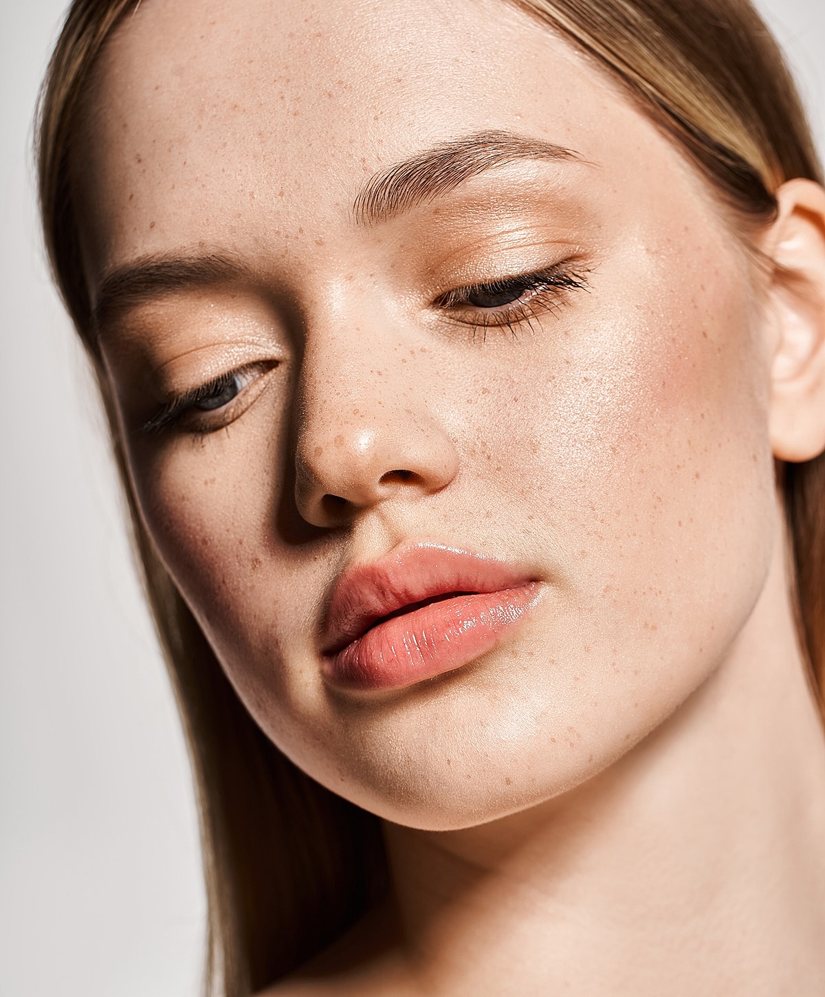 Close-up of a woman's face with freckles.