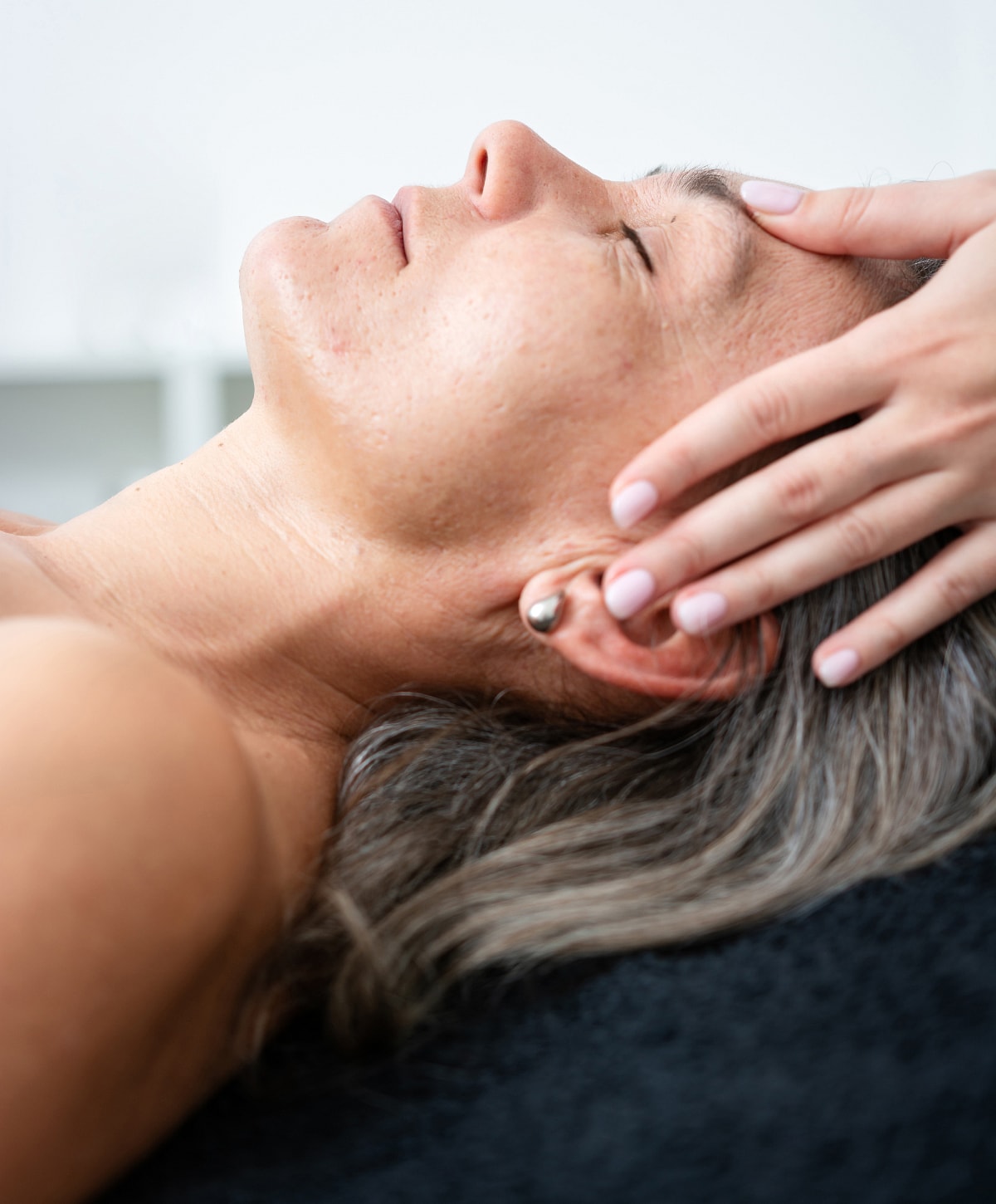 Massage therapy focusing on abdominal relaxation.