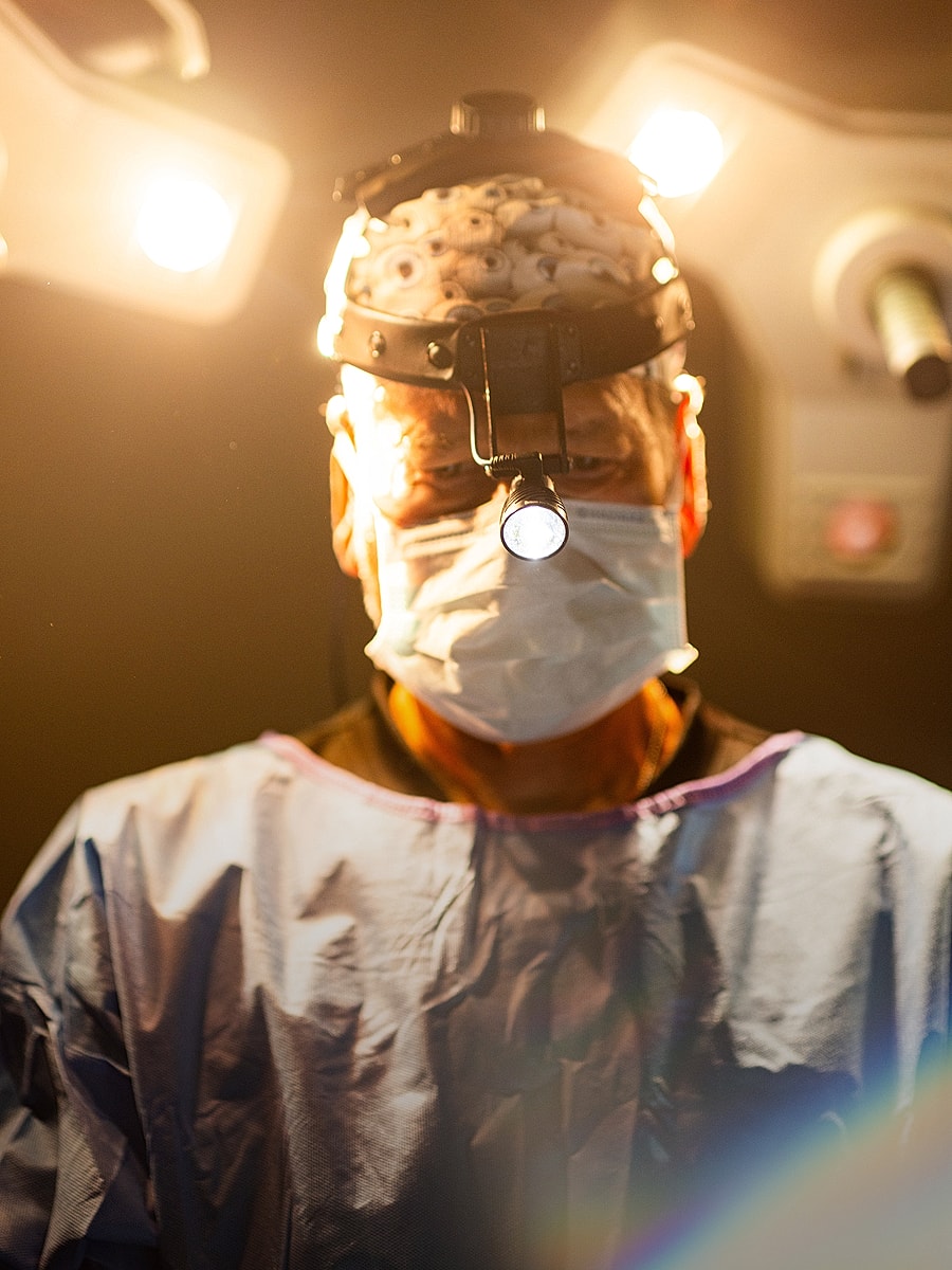 Surgeon preparing for a procedure in operating room.