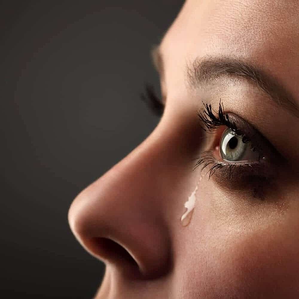 Close-up of a teary eye profile.