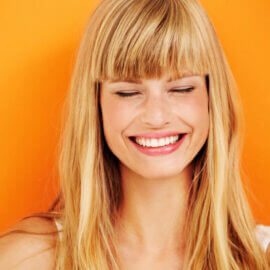 Happy young woman eyes closed portrait