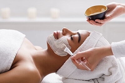 Woman getting facial in spa