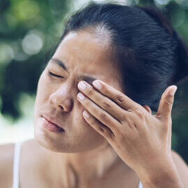 Woman rubbing her irritated eyes