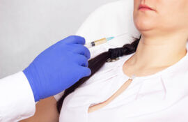The doctor makes the patient an injection of plasma therapy and lipofilling into the problem double chin, close-up