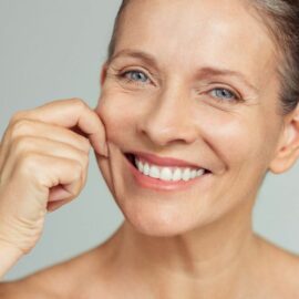 Older Woman Smiling pinching her cheek