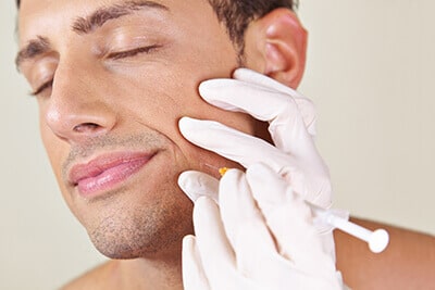 Man having botox treatment to alleviate facial spasm