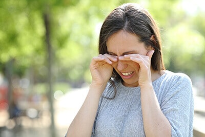 Woman pressing eyes